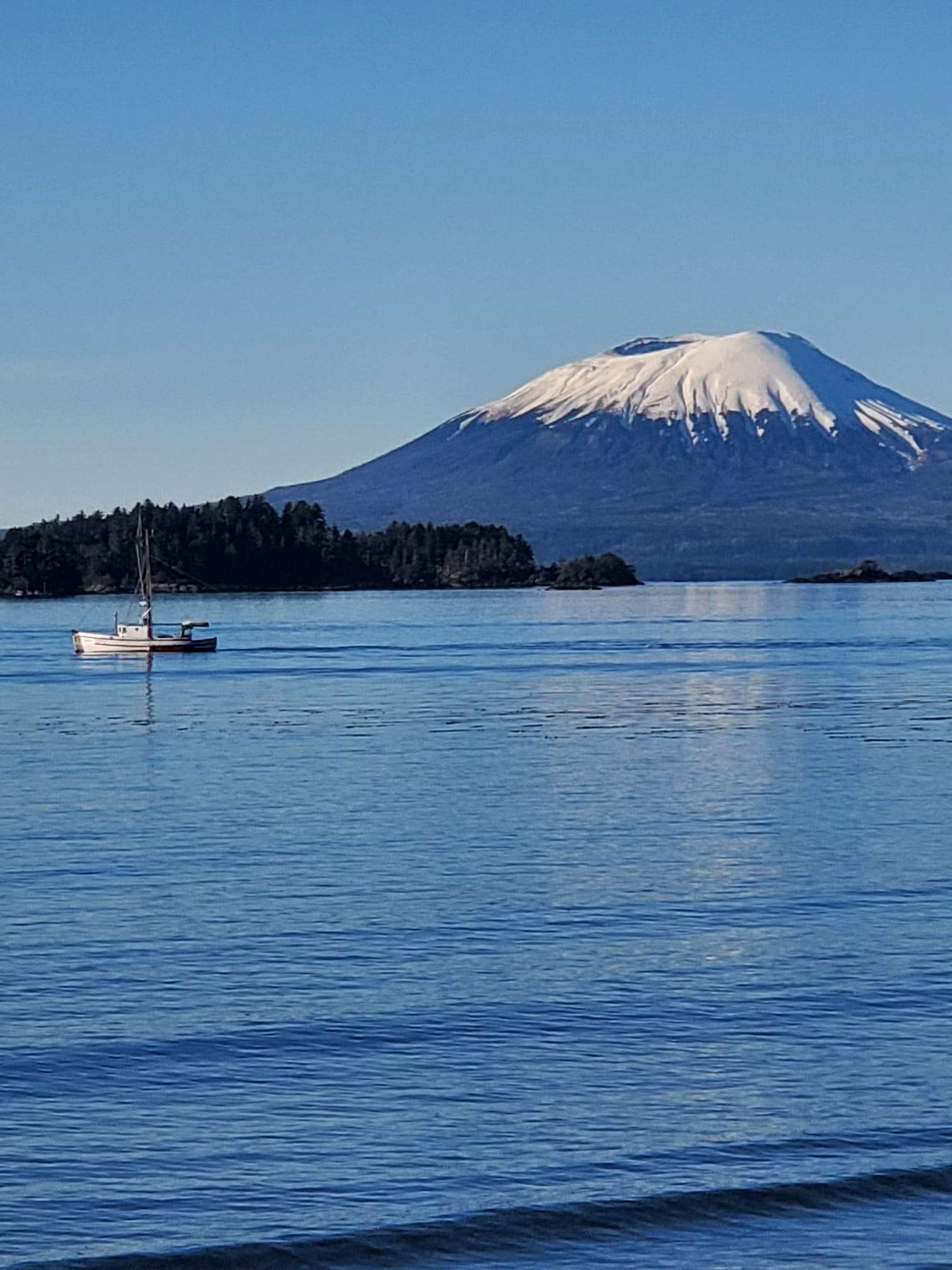 Boat on calm water with Mt. Edgecumbe